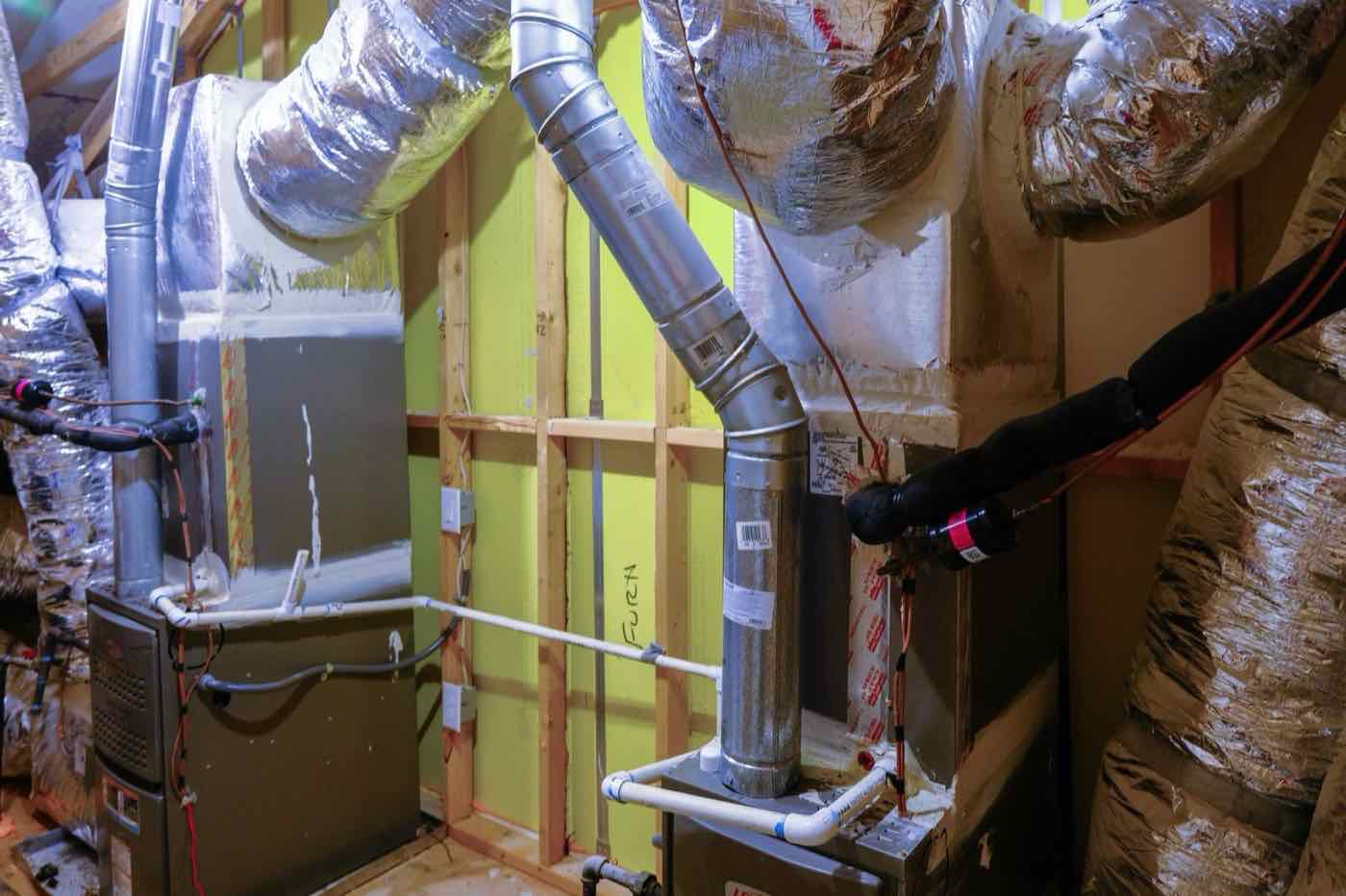 Indoor unit and new ductwork installed in a home under construction.